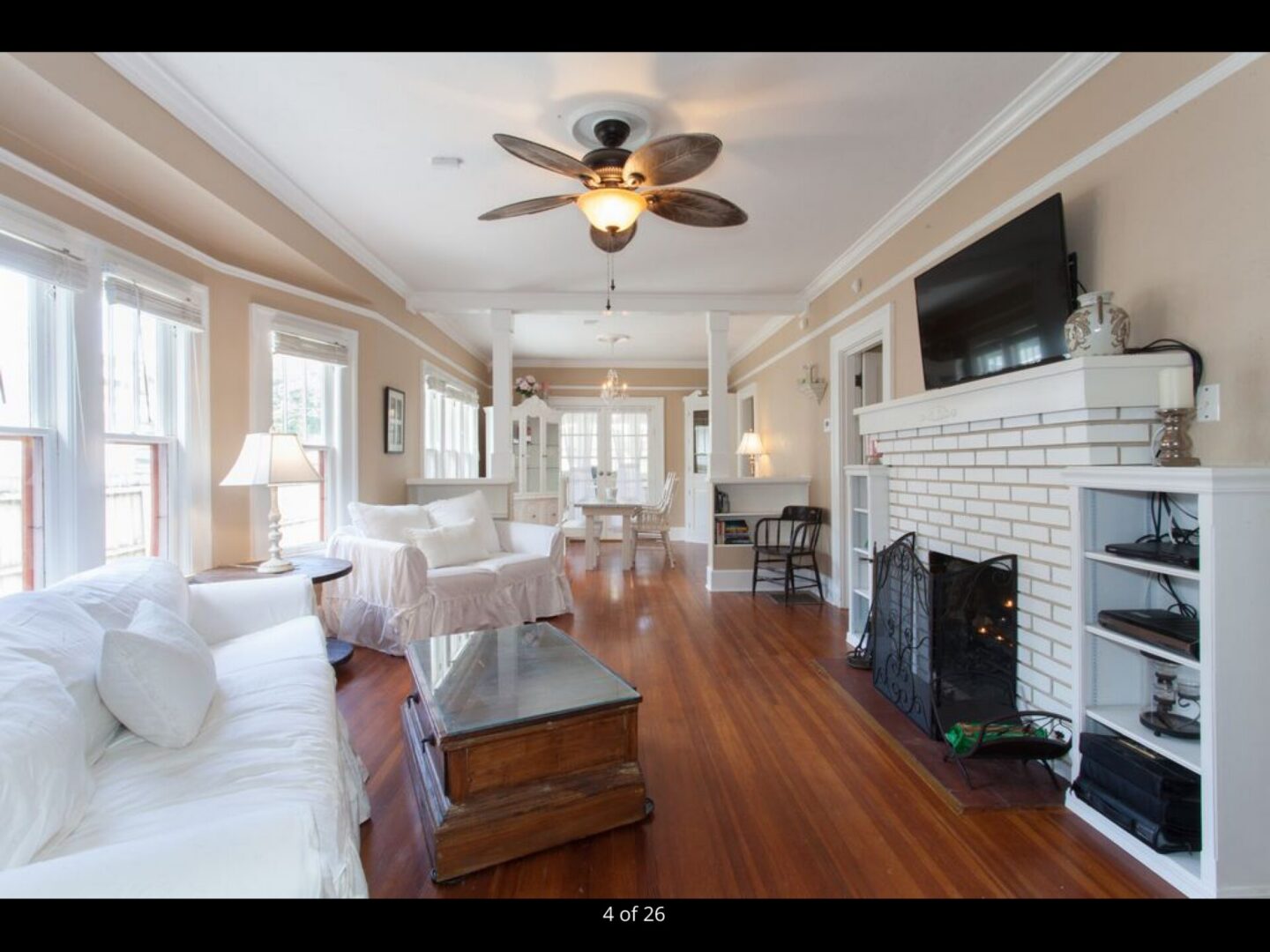 Bright living room with fireplace and ceiling fan