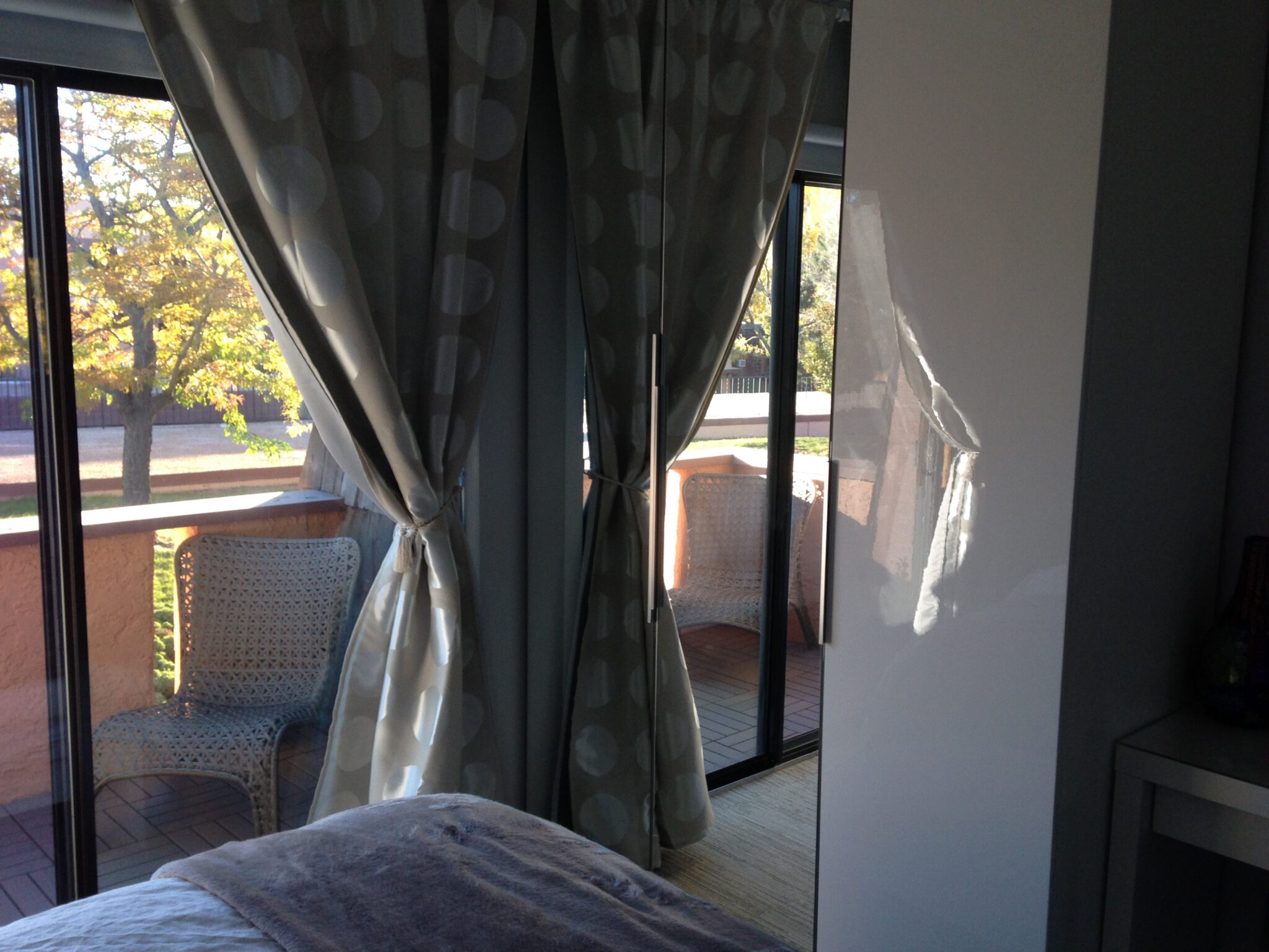 Bedroom with curtains and balcony chairs