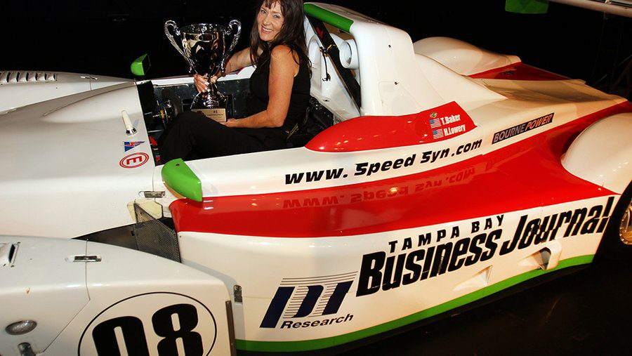 Woman holding trophy in racing powerboat