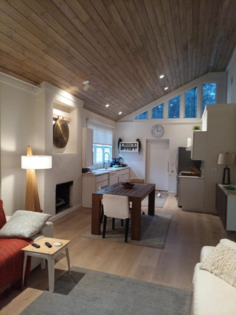Cozy open-plan living room with wood ceiling